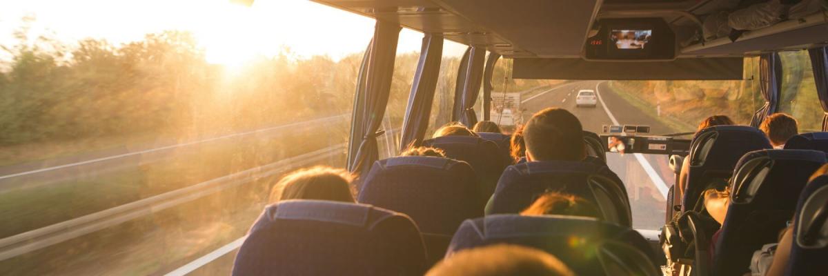 charter bus interior facing the road with sunset 